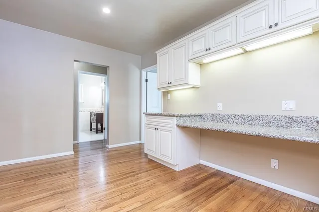 a large kitchen with stainless steel appliances granite countertop a sink and cabinets
