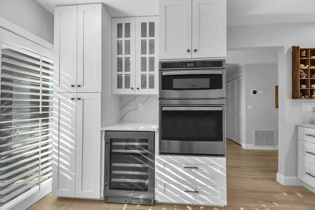 a view of a dining room and a kitchen with a table chairs