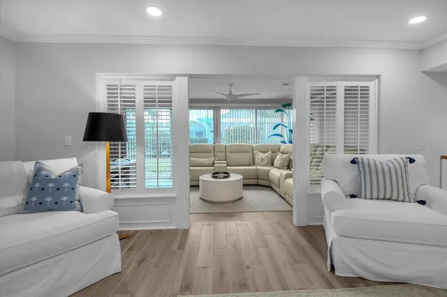 a living room with furniture and a kitchen view