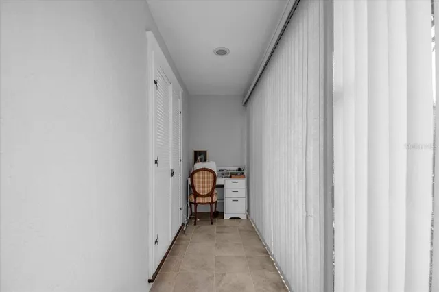 a spacious bedroom with a bed and a chair