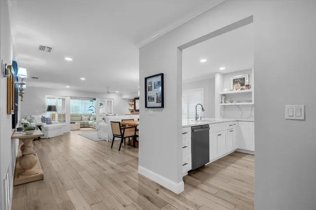 a kitchen with stainless steel appliances a refrigerator sink and cabinets