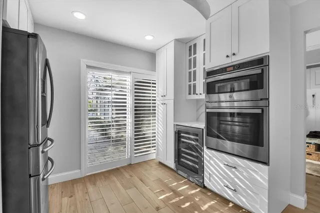 a kitchen with granite countertop white cabinets and appliances