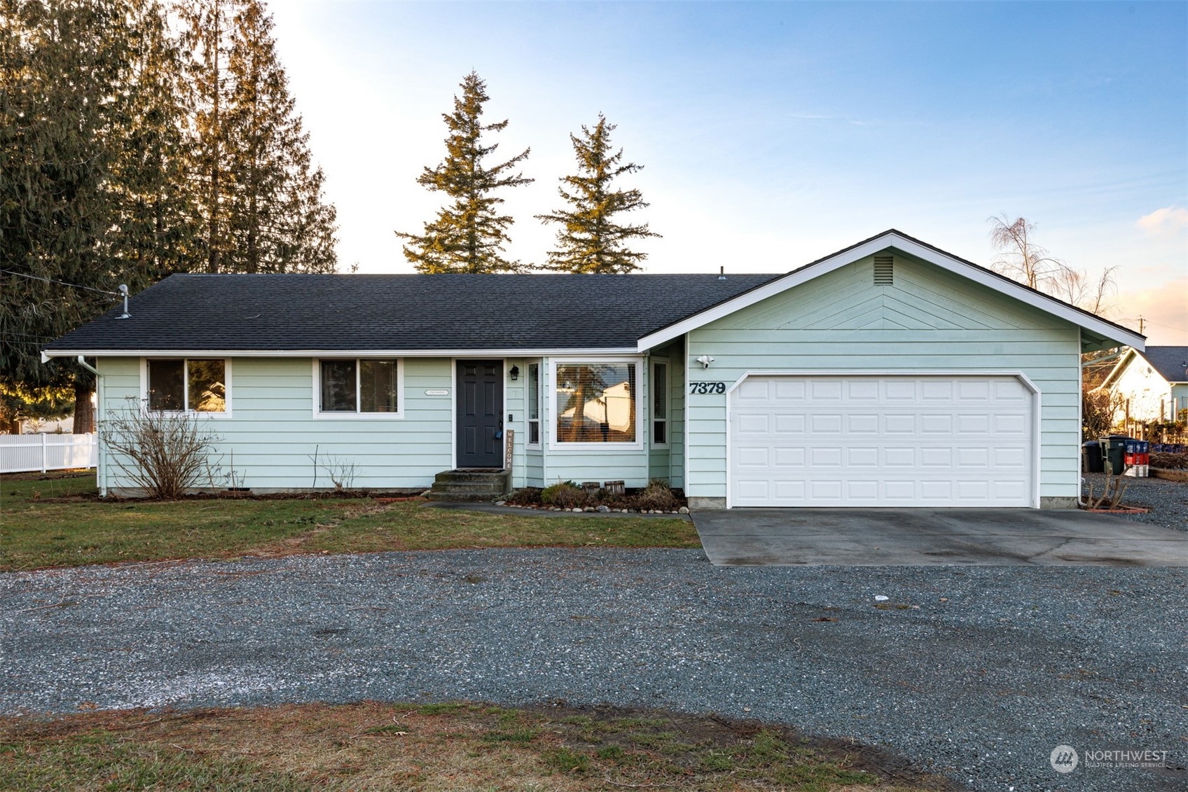 7379 Hannegan Road Lynden, WA 98264 - Photo 1 of 32 a view of a house with a yard and garage