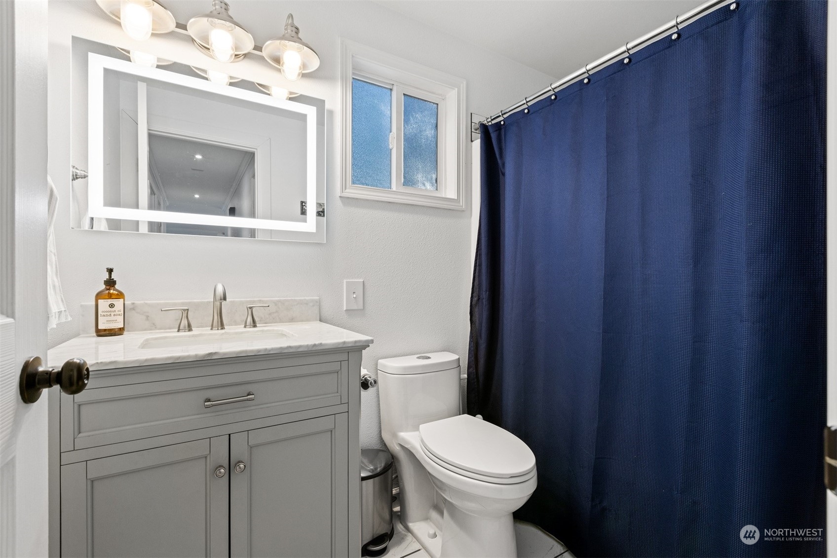 7379 Hannegan Road Lynden, WA 98264 - Photo 28 of 32 a bathroom with a toilet a sink a vanity and mirror