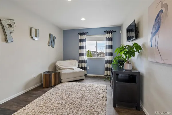 a living room with furniture and potted plant