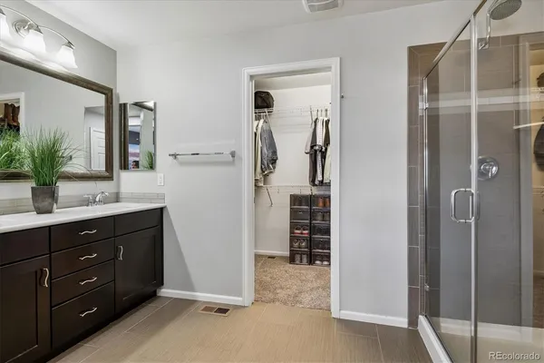 a bathroom with a shower sink and mirror