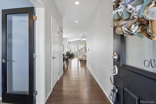 a view of a hallway with wooden floor