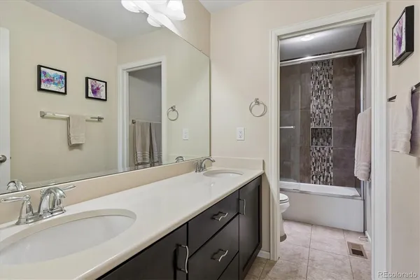 a bathroom with a tub a sink and mirror