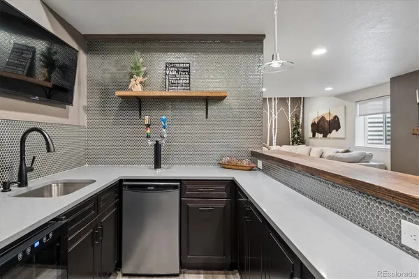 a kitchen with stainless steel appliances a sink dishwasher stove refrigerator and microwave
