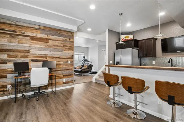 a kitchen with a table chairs stove and cabinets