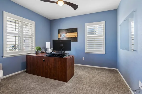 a view of workspace with furniture and window