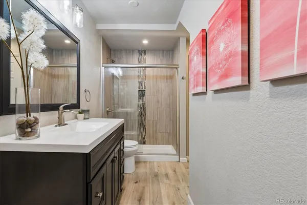 a bathroom with a sink a mirror and a shower