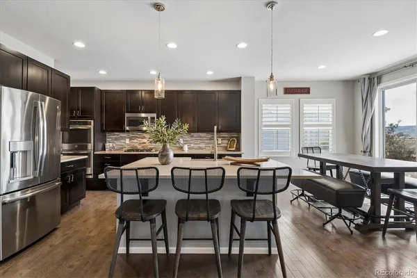 a large kitchen with a table and chairs