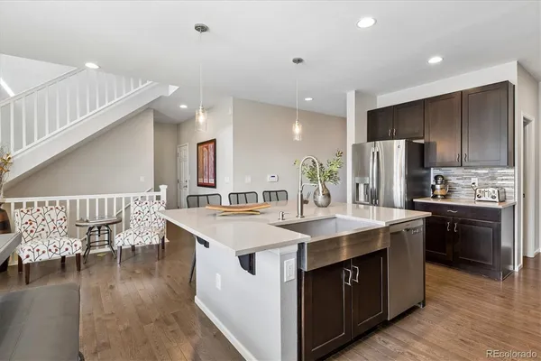a kitchen with a sink and refrigerator