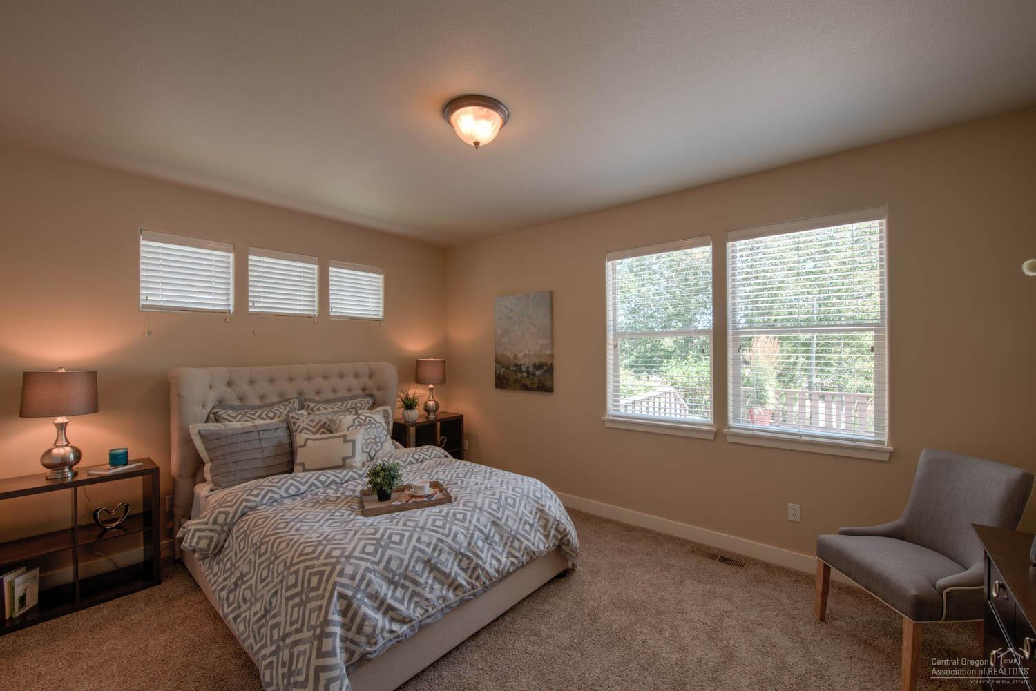 61915 Fall Creek Loop Bend, OR 97702 - Photo 11 of 24 The main level master bedroom.
