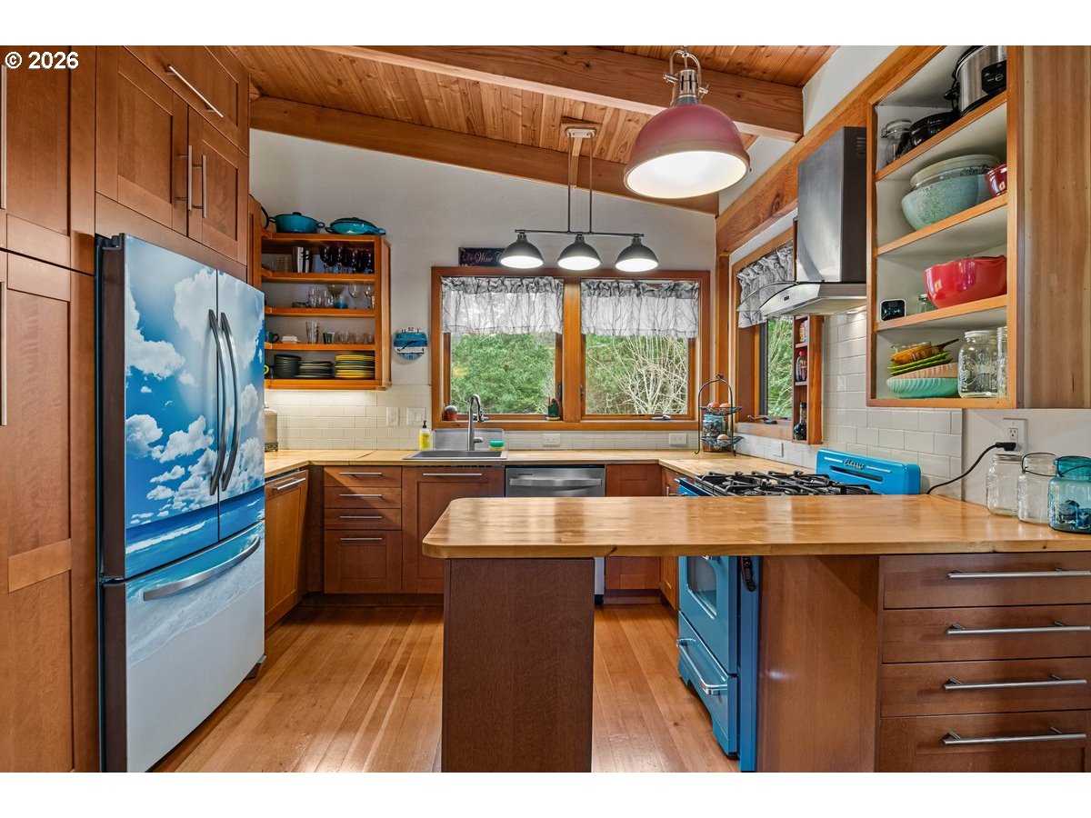 4975 Heceta Beach Road Florence, OR 97439 - Photo 11 of 48 a kitchen with stainless steel appliances granite countertop a sink and a refrigerator
