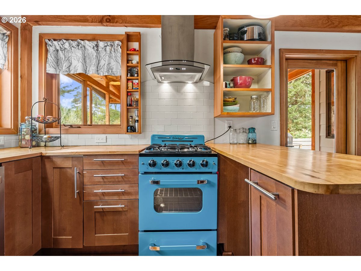 4975 Heceta Beach Road Florence, OR 97439 - Photo 16 of 48 a kitchen with stainless steel appliances granite countertop a stove and a sink