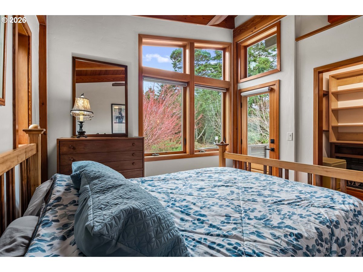 4975 Heceta Beach Road Florence, OR 97439 - Photo 22 of 48 a bedroom with a bed and a large window with outer view