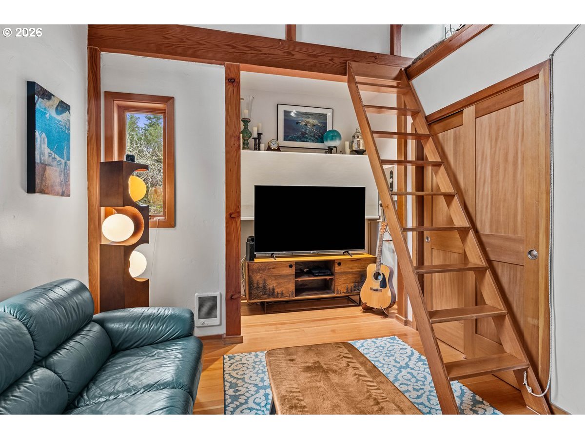 4975 Heceta Beach Road Florence, OR 97439 - Photo 29 of 48 a living room with furniture and a flat screen tv