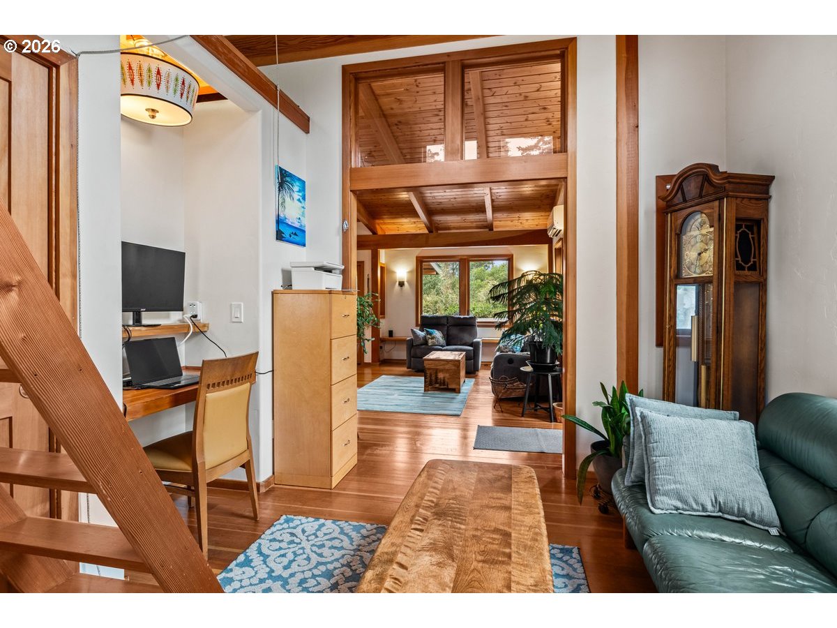 4975 Heceta Beach Road Florence, OR 97439 - Photo 30 of 48 a living room with furniture a floor to ceiling window and wooden floor