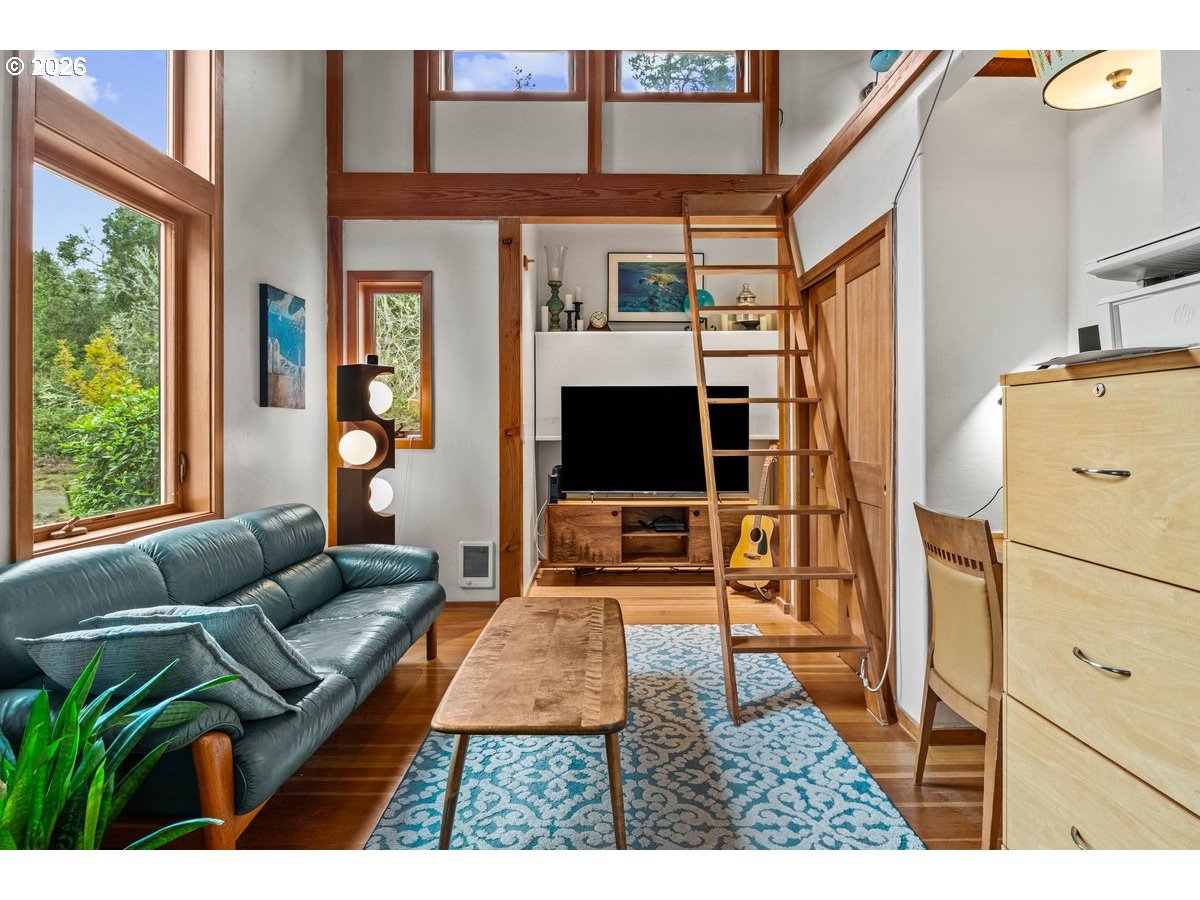 4975 Heceta Beach Road Florence, OR 97439 - Photo 32 of 48 a living room with furniture and a flat screen tv