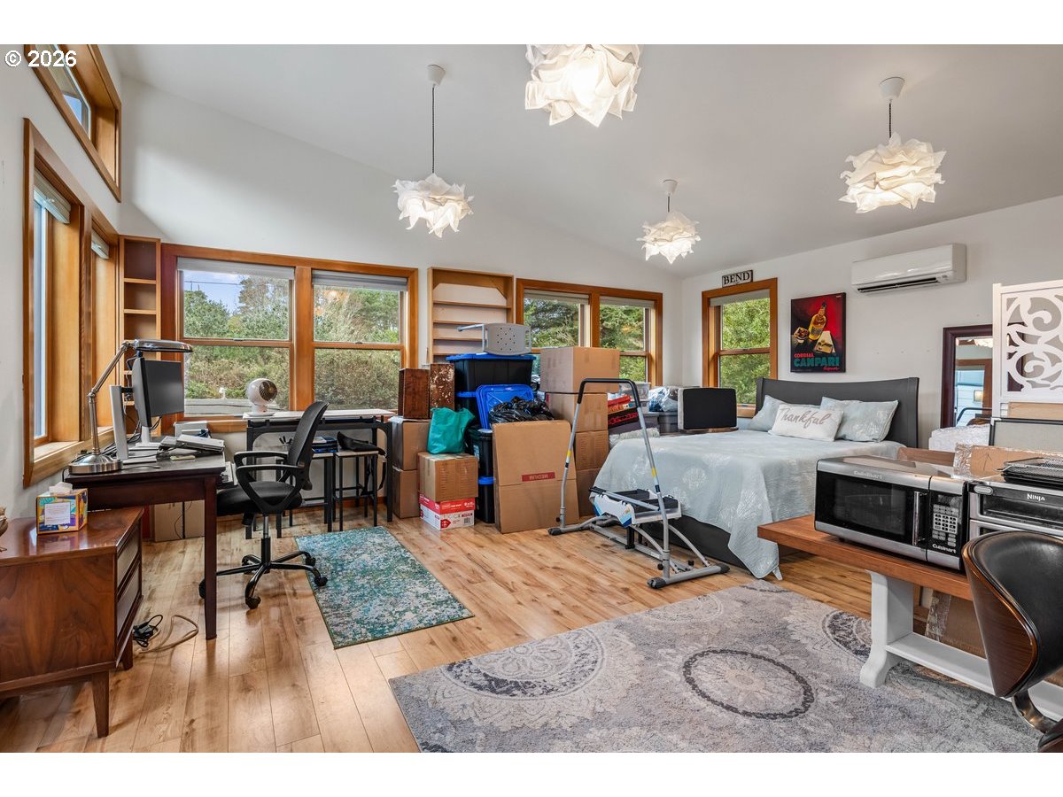 4975 Heceta Beach Road Florence, OR 97439 - Photo 35 of 48 a living room with furniture a rug and a chandelier