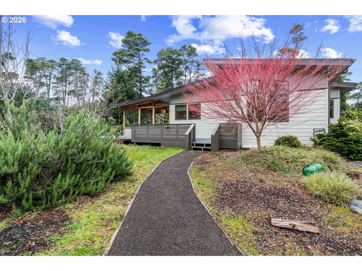 4975 Heceta Beach Road Florence, OR 97439 - Photo 38 of 48 a front view of a house with a garden