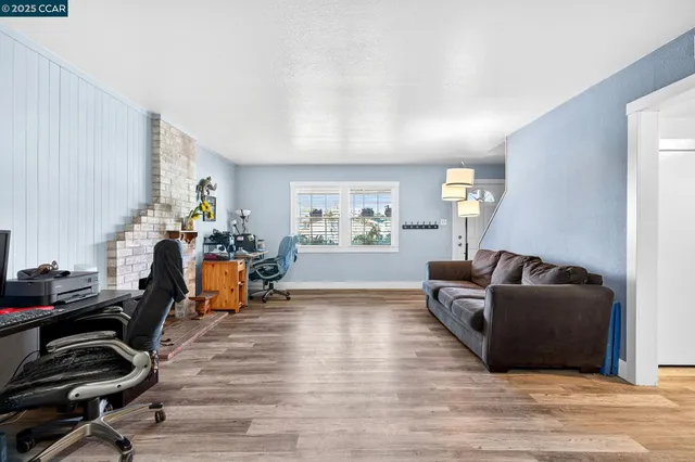 a kitchen with stainless steel appliances granite countertop a refrigerator a sink dishwasher and a stove with wooden floor