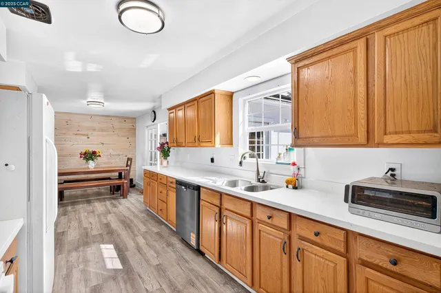 a living room with wooden floor and a book shelf
