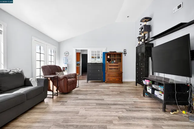 a living room with furniture and a dresser