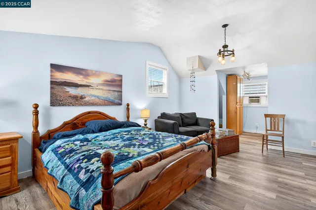 a bathroom with a granite countertop sink a mirror and shower