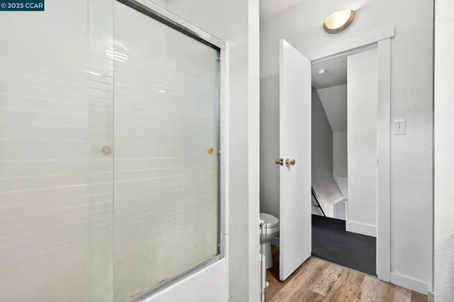 a bedroom with a bed and a flat tv screen on the dresser