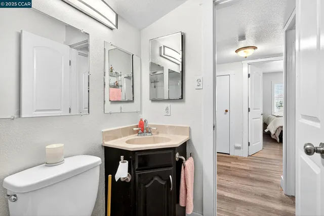 a white toilet sitting next to a bathroom sink