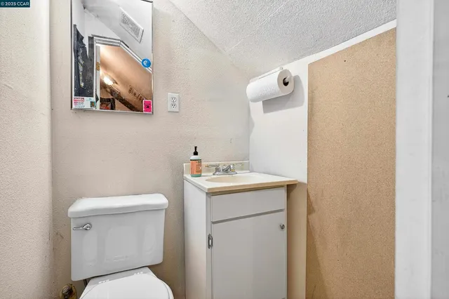 a patio with a table and chairs under an umbrella