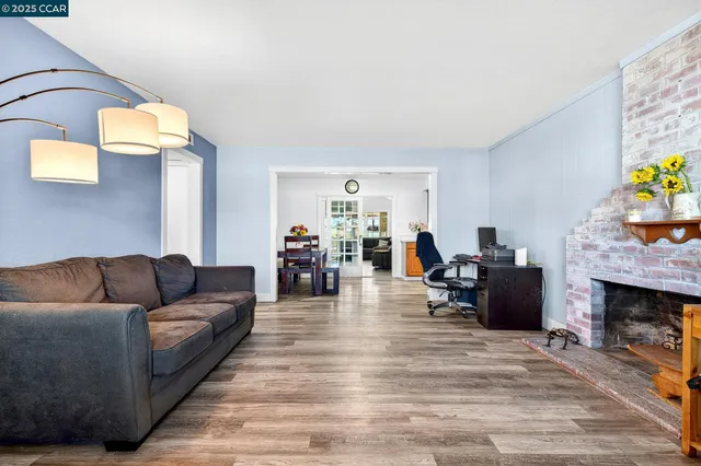a living room with furniture and a gym cycle