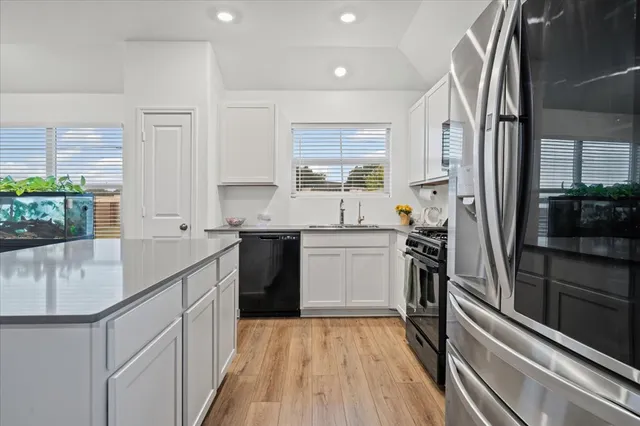 a kitchen with a sink stove and refrigerator