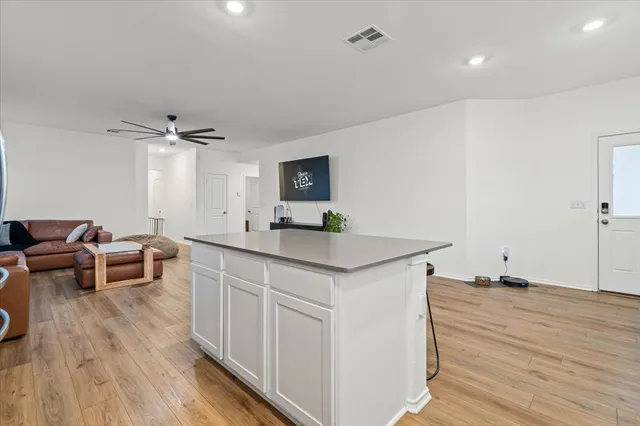 a view of kitchen island wooden floor furniture and a living room view
