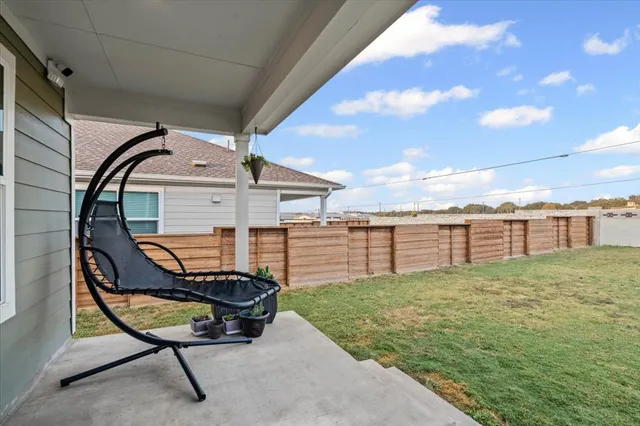 a view of a backyard with sitting area
