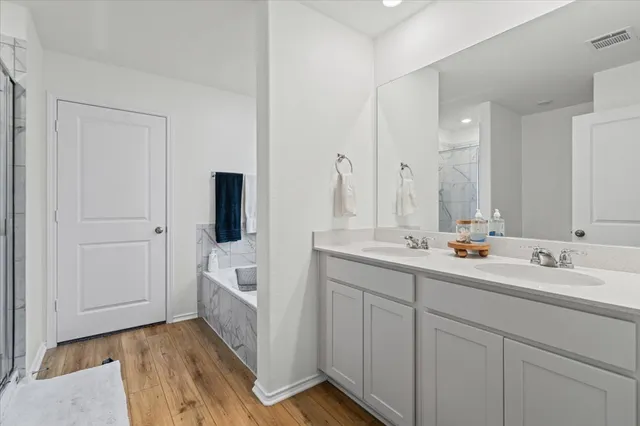 a bathroom with a double vanity sink and mirror
