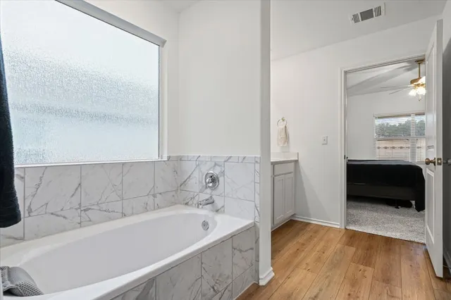 a bathroom with a bathtub and a shower