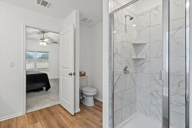a bathroom with a shower and a toilet