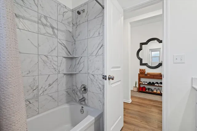 a bathroom with a bathtub and shower