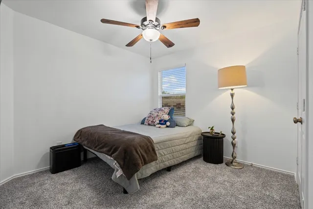 a bedroom with bed and a window