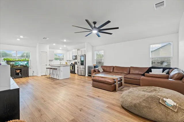a living room with furniture and kitchen view