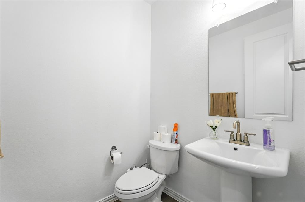 6535 Baritone Court Sachse, TX 75048 - Photo 10 of 24 a bathroom with a sink mirror and toilet