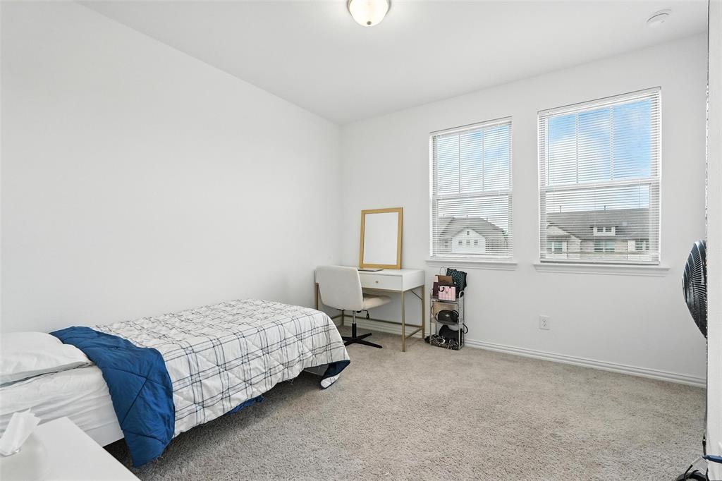 6535 Baritone Court Sachse, TX 75048 - Photo 12 of 24 a bedroom with a bed and a window