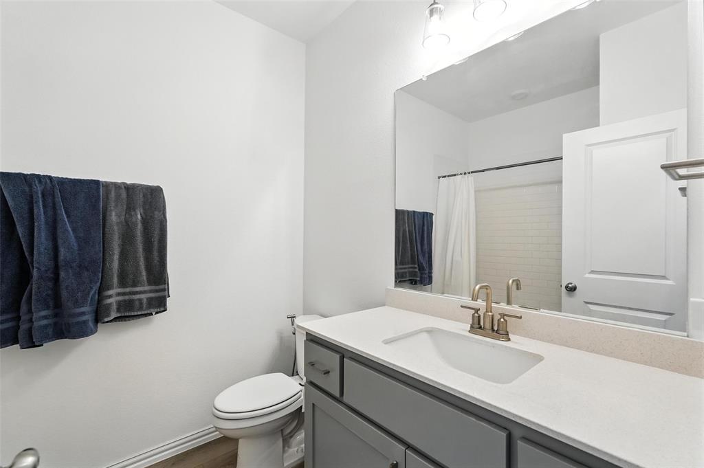 6535 Baritone Court Sachse, TX 75048 - Photo 13 of 24 a bathroom with a granite countertop sink vanity mirror and toilet