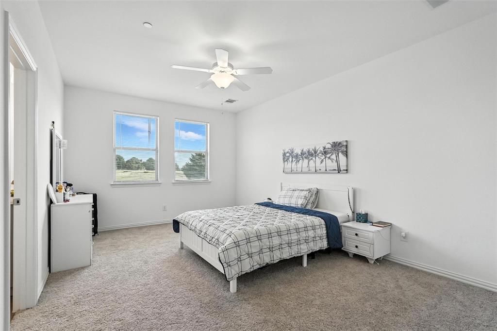 6535 Baritone Court Sachse, TX 75048 - Photo 16 of 24 a bedroom with a bed and a window