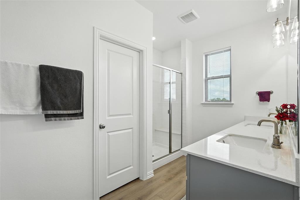 6535 Baritone Court Sachse, TX 75048 - Photo 17 of 24 a bathroom with a sink and a mirror