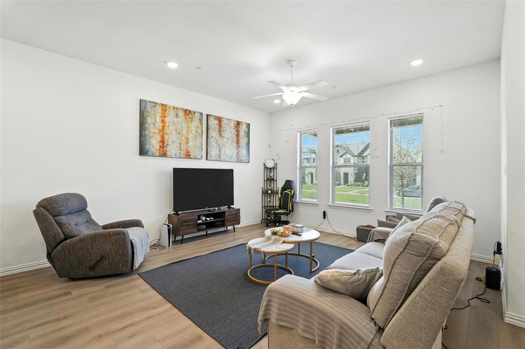 6535 Baritone Court Sachse, TX 75048 - Photo 2 of 24 a living room with furniture and a flat screen tv